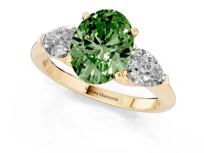 Fancy Green Three-Stone Oval Cut Diamond Ring Set in Yellow gold with Pear Side Stones and Prong Setting