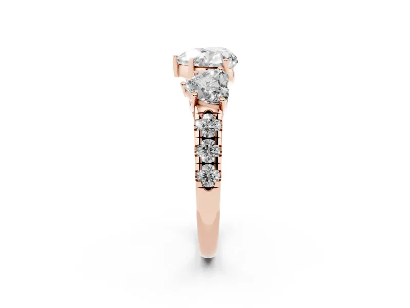 Heart Cut Diamond Three-Stone Ring Set in Rose gold with Pavé Band