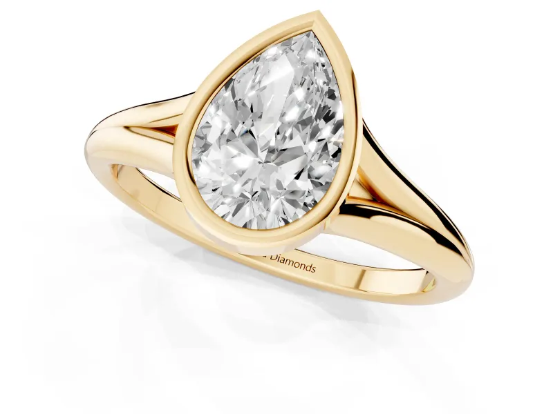 Bezel Set Pear Cut Diamond Solitaire Ring Set in Yellow gold with Tapered Band