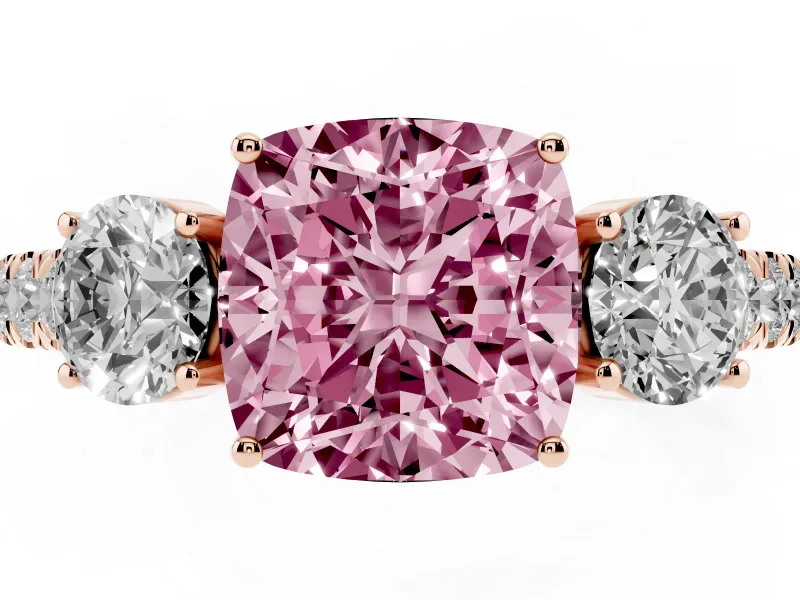 Fancy Pink Cushion Cut Diamond Three-Stone Ring Set in Rose gold with Round Side Stones and Delicate Pavé Band