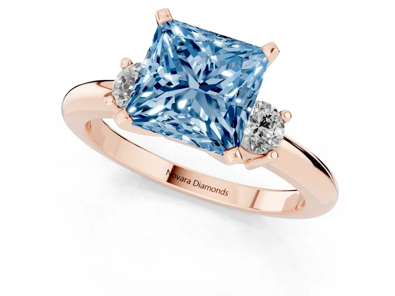 Fancy Blue Three-Stone Princess Cut Diamond Ring Set in Rose gold with Prong Setting and Plain Band
