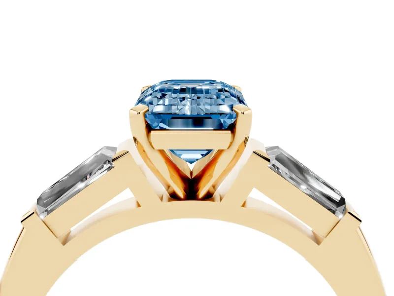 Fancy Blue Emerald Cut Diamond Solitaire Ring Set in Yellow gold with Tapered Baguette Side Stones and Prong Setting