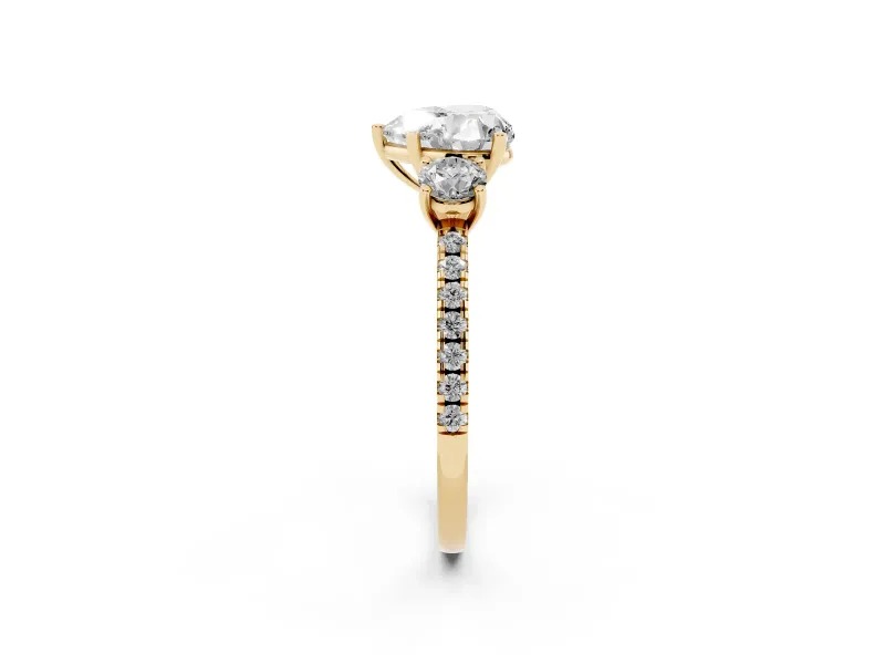 Heart Cut Diamond Three-Stone Ring Set in Yellow gold with Pavé Band and Graduated Sides