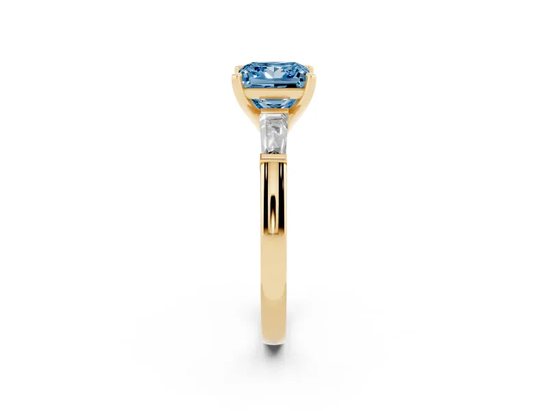 Fancy Blue Princess Cut Diamond Solitaire Ring Set in Yellow gold with Tapered Baguette Side Stones and Prong Setting