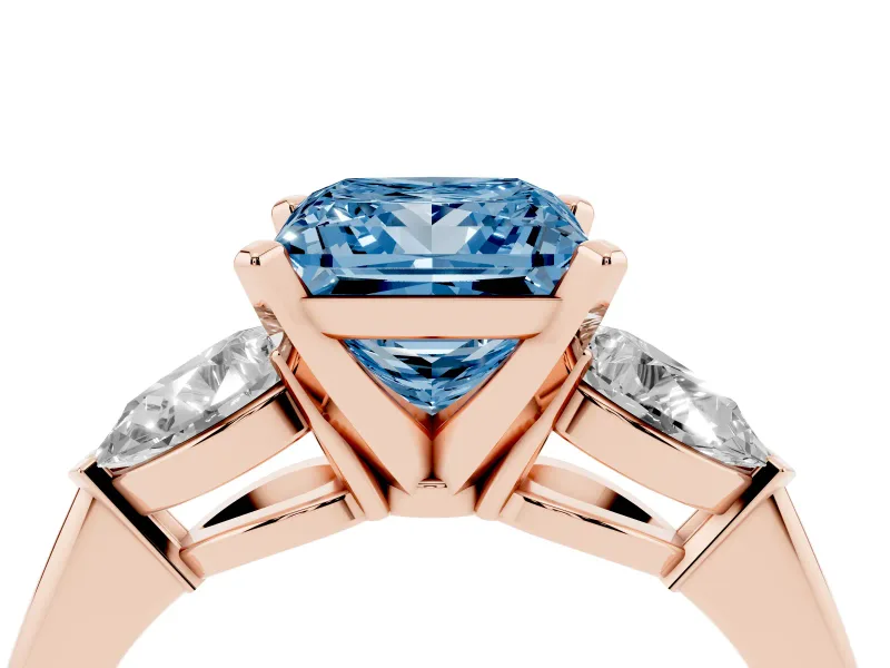 Fancy Blue Three-Stone Princess Cut Diamond Ring Set in Rose gold with Pear Side Stones and Prong Setting