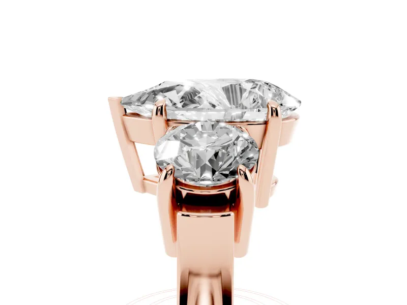 Pear Cut Diamond Three-Stone Ring Set in Rose gold with Round Accent Stones and Plain Band