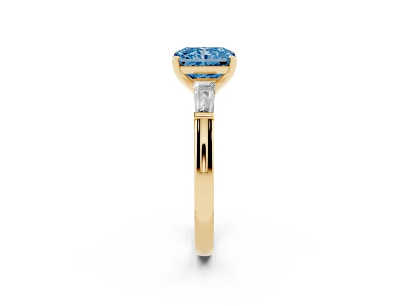 Fancy Blue Radiant Cut Diamond Solitaire Ring Set in Yellow gold with Tapered Baguette Side Stones and Prong Setting