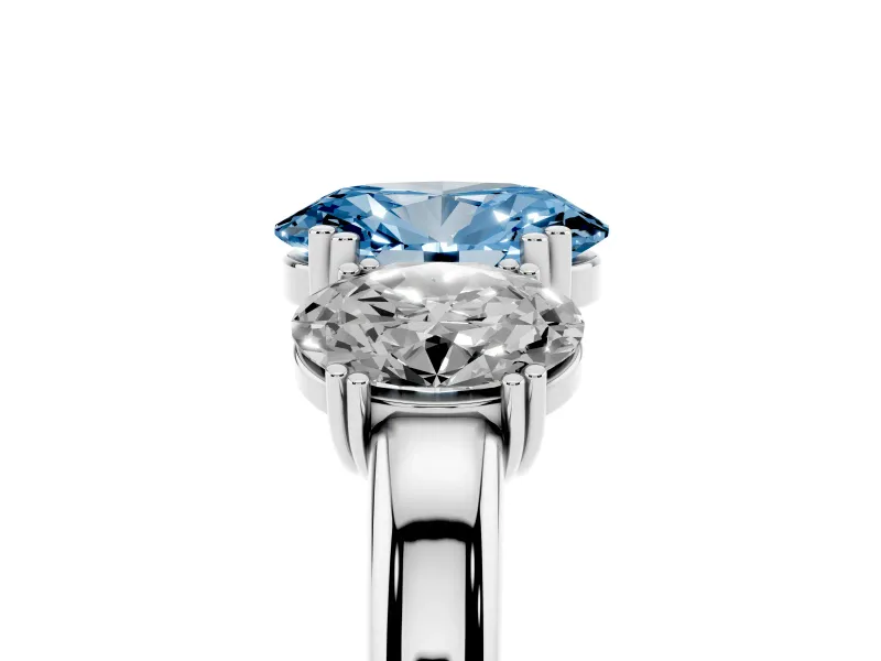 Fancy Blue Oval Cut Diamond Three-Stone Ring Set in Platinum with Polished Band and Prong Setting