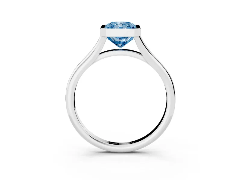 Fancy Blue Bezel Set Radiant Cut Diamond Solitaire Ring Set in White gold with Tapered Band
