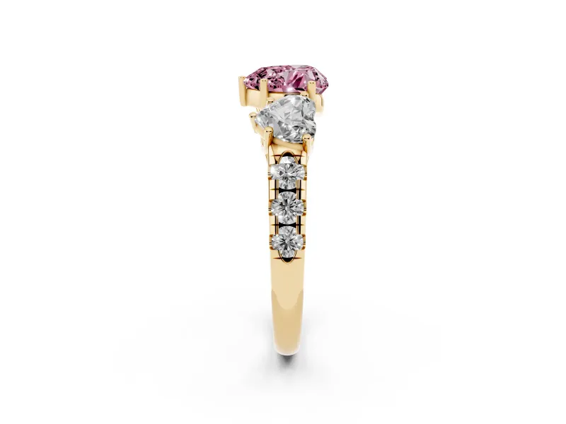 Fancy Pink Heart Cut Diamond Three-Stone Ring Set in Yellow gold with Pavé Band