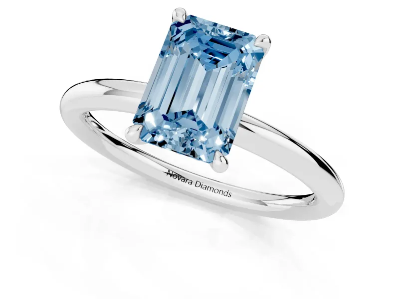 Fancy Blue Emerald Cut Diamond Solitaire Ring Set in Platinum with Thin Band and Prong Setting