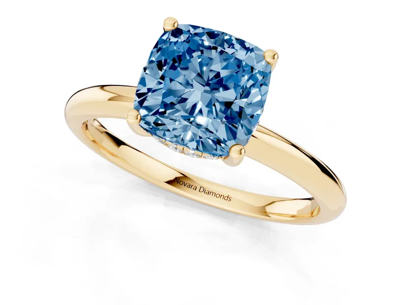 Fancy Blue Cushion Cut Diamond Solitaire Engagement Ring Set in Yellow gold with Prong Setting and Polished Band