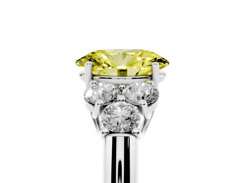 Fancy Yellow Oval Cut Diamond Cluster Ring Set in Platinum with Round Accent Stones and Prong Setting on a Plain Band