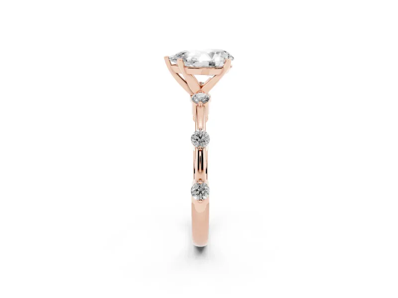 Pear Cut Diamond Solitaire Ring Set in Rose gold with Bezel Set Side Stones and Prong Setting