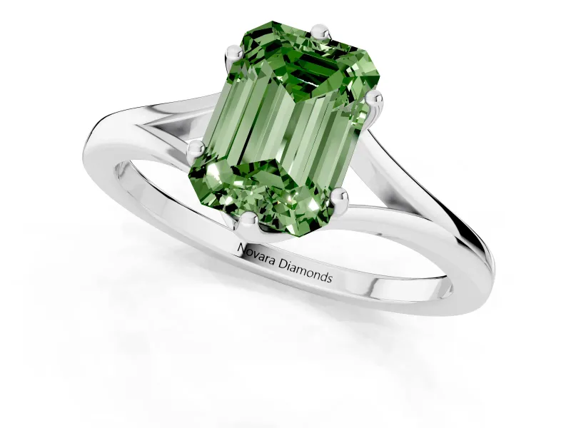 Fancy Green Emerald Cut Diamond Solitaire Ring Set in White gold with Polished Tapered Band and Prong Setting