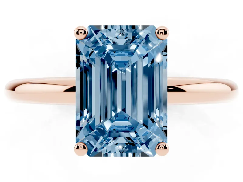 Fancy Blue Emerald Cut Diamond Solitaire Engagement Ring Set in Rose gold with Prong Setting and Polished Band