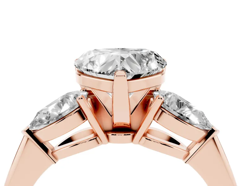 Three-Stone Heart Cut Diamond Ring Set in Rose gold with Pear Side Stones and Prong Setting