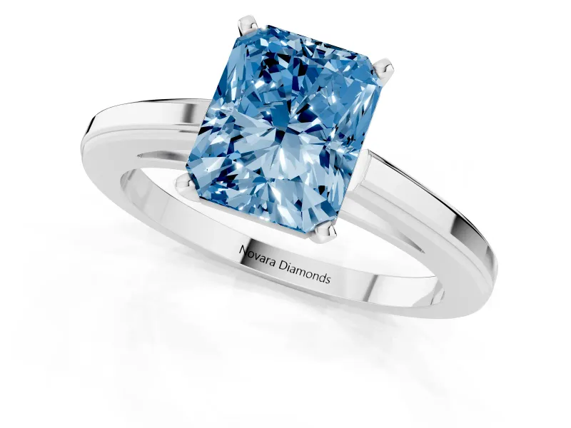 Fancy Blue Radiant Cut Diamond Solitaire Ring Set in Platinum with Prong Setting and Classic Band