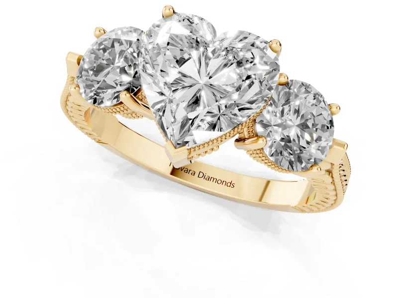 Heart Cut Diamond Three-Stone Ring Set in Yellow gold with Milgrain Band