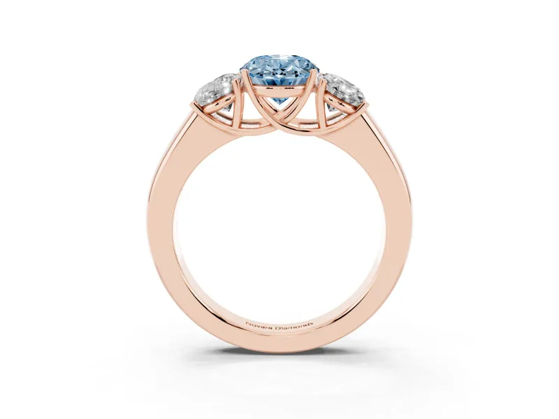 Fancy Blue Three-Stone Oval Cut Diamond Ring Set in Rose gold with Matching Prong Settings and Plain Band