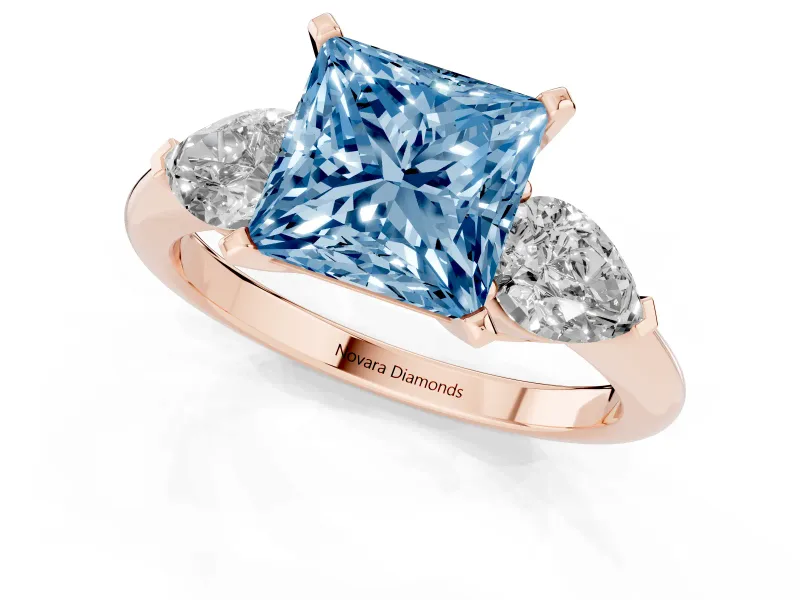 Fancy Blue Three-Stone Princess Cut Diamond Ring Set in Rose gold with Pear Side Stones and Prong Setting