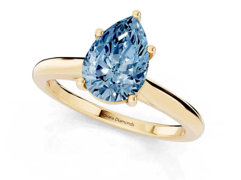 Fancy Blue Pear Cut Diamond Solitaire Ring Set in Yellow gold with Cathedral Band and Prong Setting