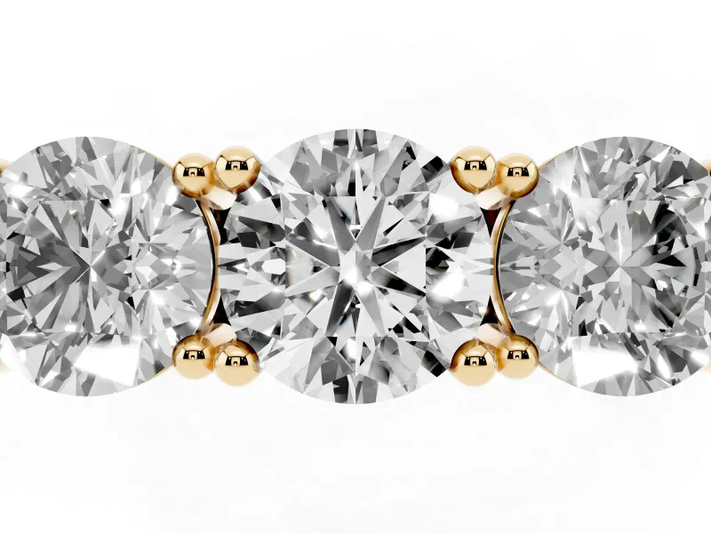 Round Cut Diamond Three-Stone Ring Set in Yellow gold with Channel Band and Sturdy Prongs