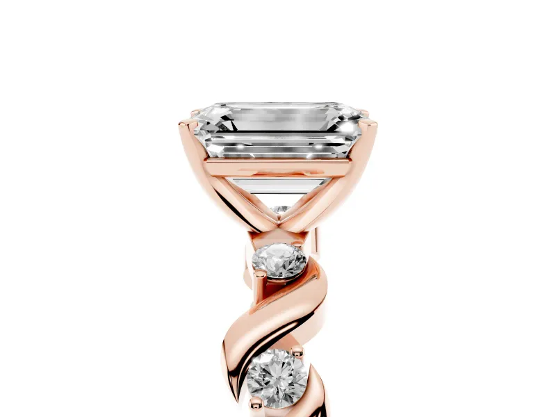Emerald Cut Diamond Solitaire Ring Set in Rose gold with Ribbon Twist Band, Round Accents and Prong Setting