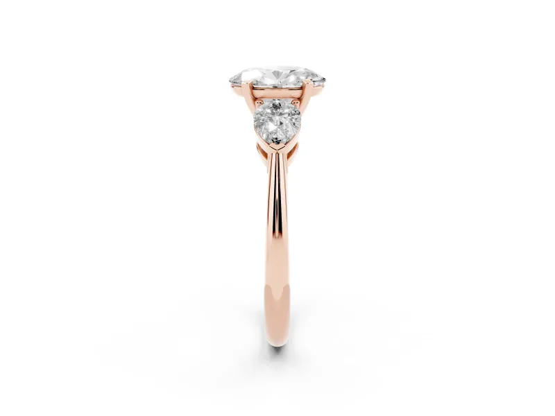 Three-Stone Oval Cut Diamond Ring Set in Rose gold with Pear Side Stones and Prong Setting