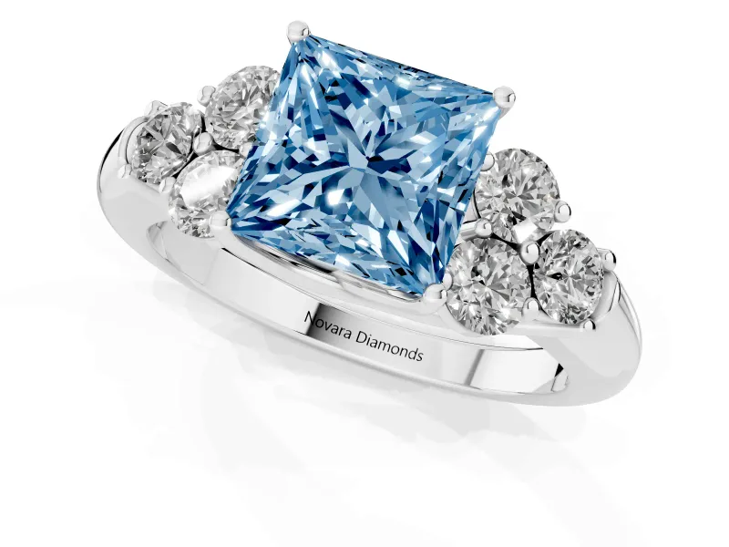 Fancy Blue Princess Cut Diamond Cluster Ring Set in Platinum with Round Accent Stones and Prong Setting on a Plain Band