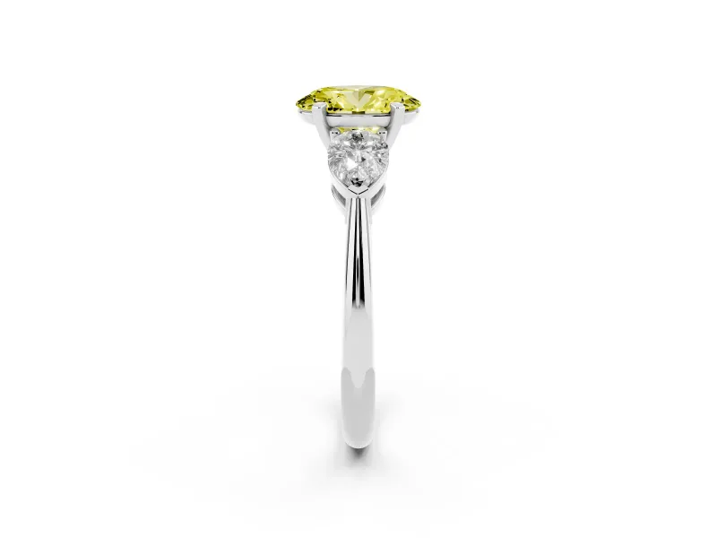 Fancy Yellow Three-Stone Oval Cut Diamond Ring Set in Platinum with Pear Side Stones and Prong Setting