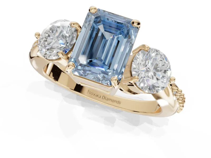 Emerald Cut Three Stone Engagement Ring Setting for a Fancy Blue Lab-Grown Diamond | Tapered Pave Band | Yellow Gold