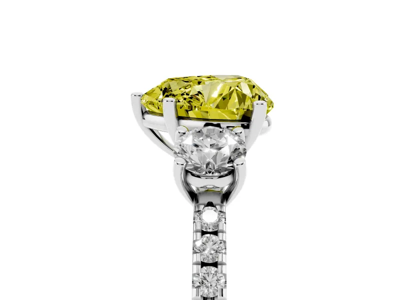 Fancy Yellow Heart Cut Diamond Three-Stone Ring Set in Platinum with Pavé Band and Graduated Sides