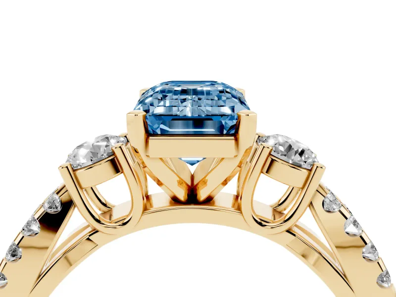 Fancy Blue Emerald Cut Diamond Three-Stone Ring Set in Yellow gold with Pavé Split Shank and Prong Setting