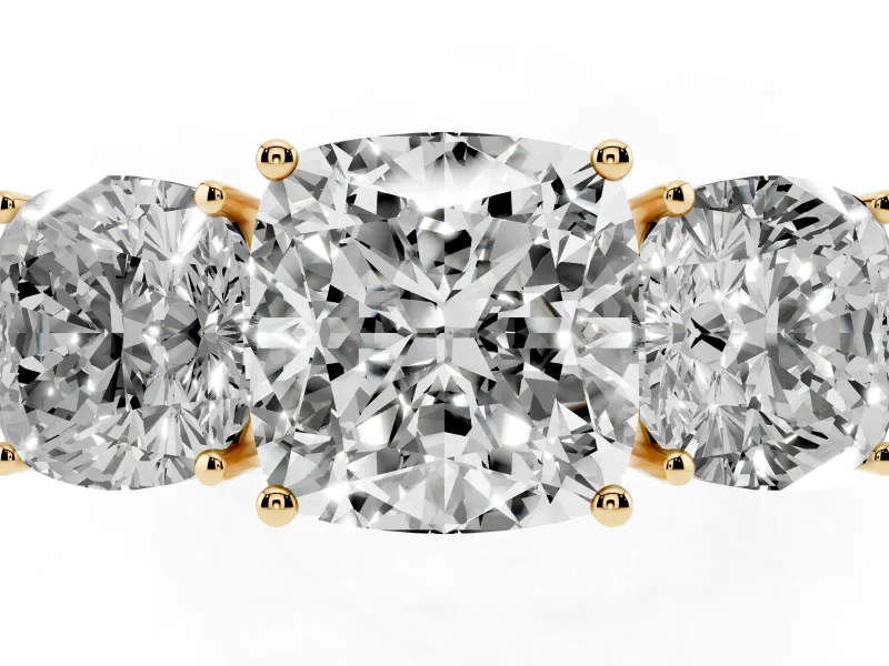Cushion Cut Diamond Three-Stone Ring Set in Yellow gold with Textured Band