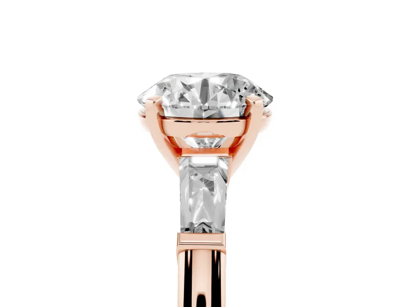Round Cut Diamond Solitaire Ring Set in Rose gold with Tapered Baguette Side Stones and Prong Setting