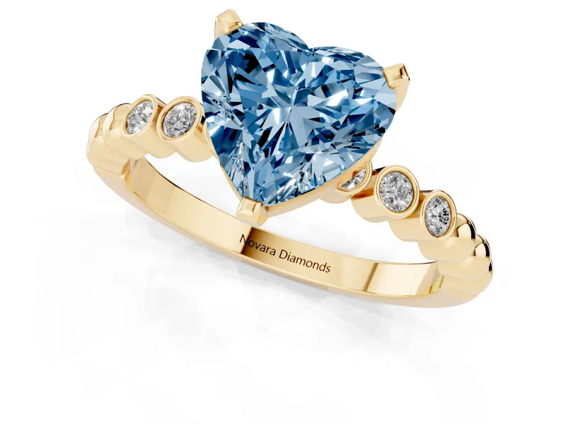 Fancy Blue Heart Cut Diamond Solitaire Engagement Ring Set in Yellow gold with Bezel Accents on Beaded Band