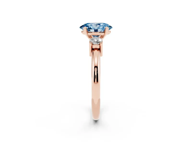Fancy Blue Three-Stone Oval Cut Diamond Ring Set in Rose gold with Prong Setting and Plain Band