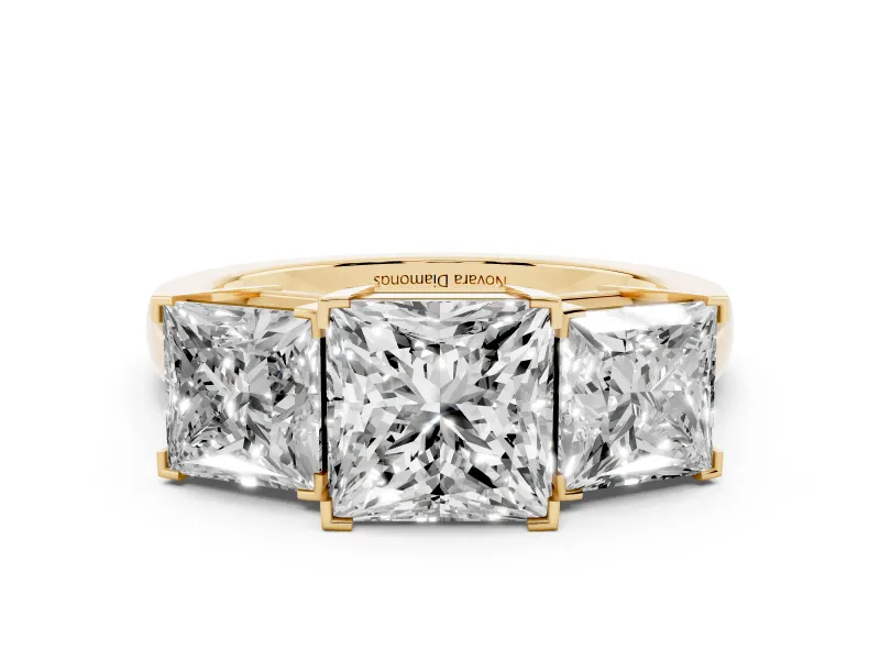 Princess Cut Diamond Three-Stone Ring Set in Yellow gold with Channel-Set Band and Prong Settings