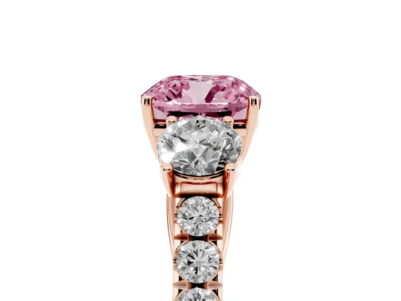 Fancy Pink Cushion Cut Diamond Three-Stone Ring Set in Rose gold with Round Side Stones and Delicate Pavé Band