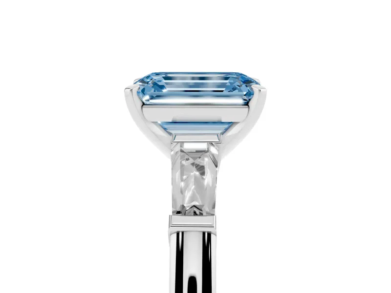 Fancy Blue Emerald Cut Diamond Solitaire Ring Set in Platinum with Tapered Baguette Side Stones and Prong Setting
