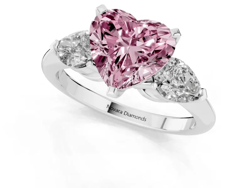 Fancy Pink Three-Stone Heart Cut Diamond Ring Set in White gold with Pear Side Stones and Prong Setting