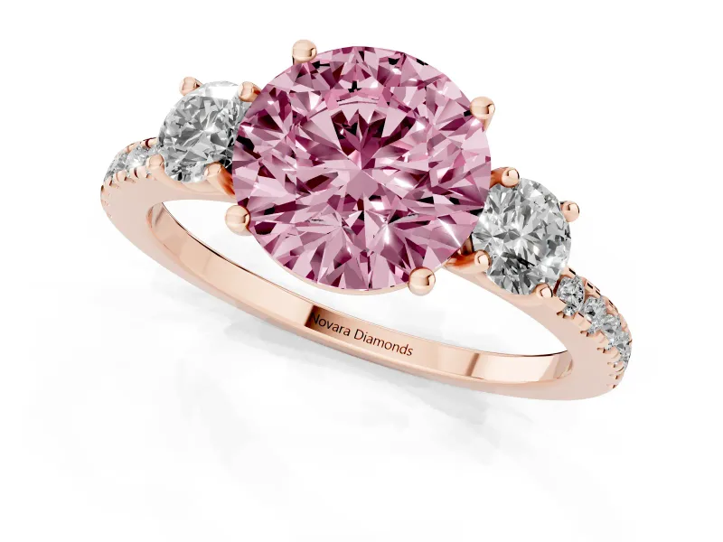 Fancy Pink Round Cut Diamond Three-Stone Ring Set in Rose gold with Pavé Band and Graduated Sides
