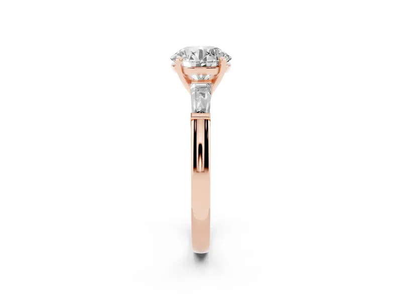Round Cut Diamond Solitaire Ring Set in Rose gold with Tapered Baguette Side Stones and Prong Setting