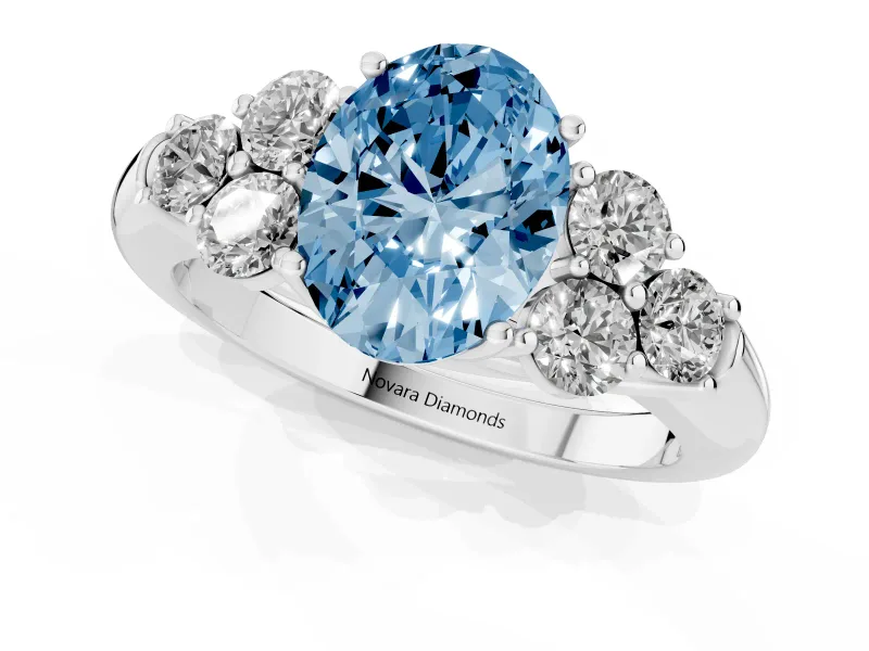 Fancy Blue Oval Cut Diamond Cluster Ring Set in White gold with Round Accent Stones and Prong Setting on a Plain Band