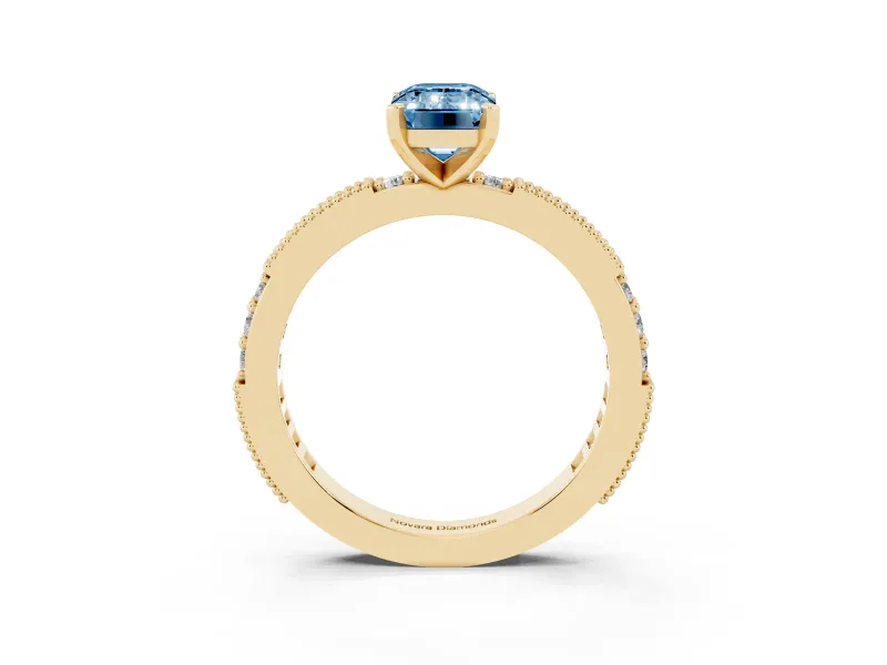 Fancy Blue Emerald Cut Diamond Solitaire Ring Set in Yellow gold with Slim Pavé Band and Prong Setting