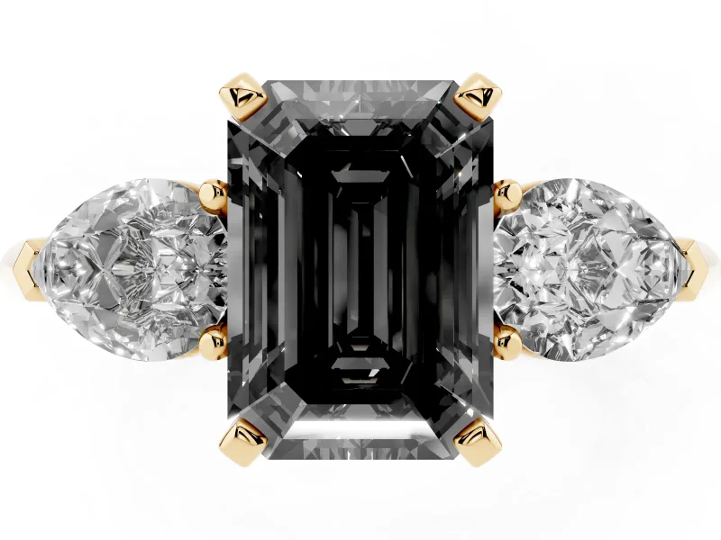 Fancy Black Three-Stone Emerald Cut Diamond Ring Set in Yellow gold with Pear Side Stones and Prong Setting