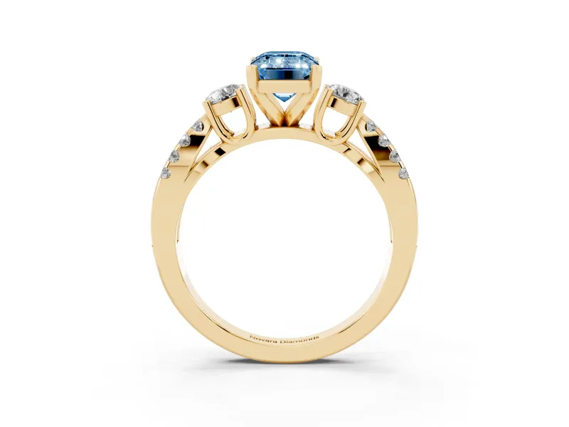 Fancy Blue Emerald Cut Diamond Three-Stone Ring Set in Yellow gold with Pavé Split Shank and Prong Setting