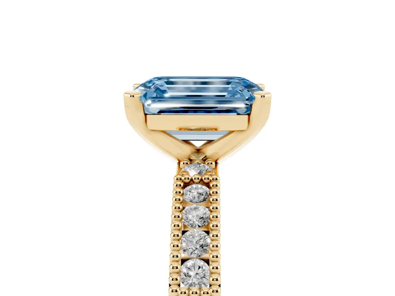 Fancy Blue Emerald Cut Diamond Solitaire Ring Set in Yellow gold with Slim Pavé Band and Prong Setting