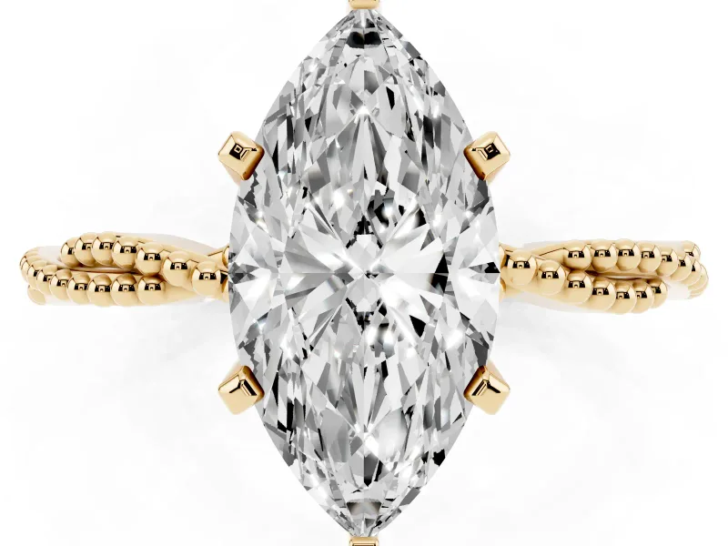 Marquise Cut Diamond Solitaire Ring Set in Yellow gold with Twisted Band and Bead Prong Setting